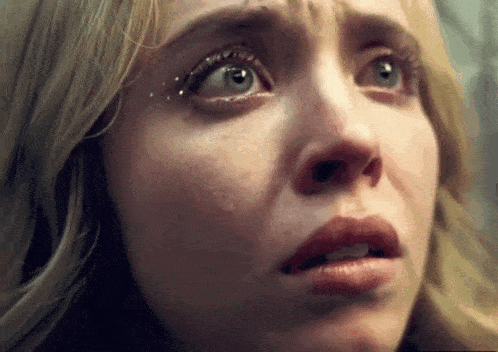 a close up of a woman 's face with her eyes closed