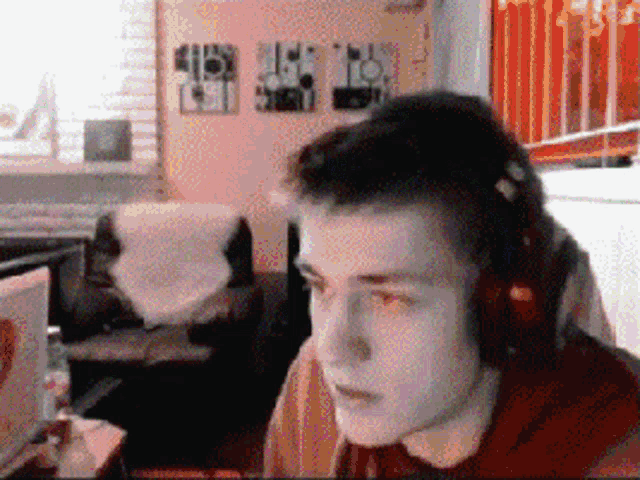 a man wearing headphones is looking at something