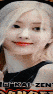 a close up of a woman 's face with a kai-zen logo in the corner