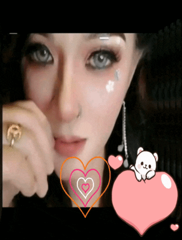 a woman with a ring on her finger is surrounded by pink hearts and a teddy bear