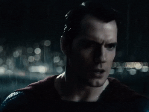 a close up of a man 's face in the dark
