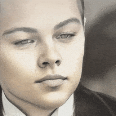 a close up of a man 's face with his eyes closed and his mouth open
