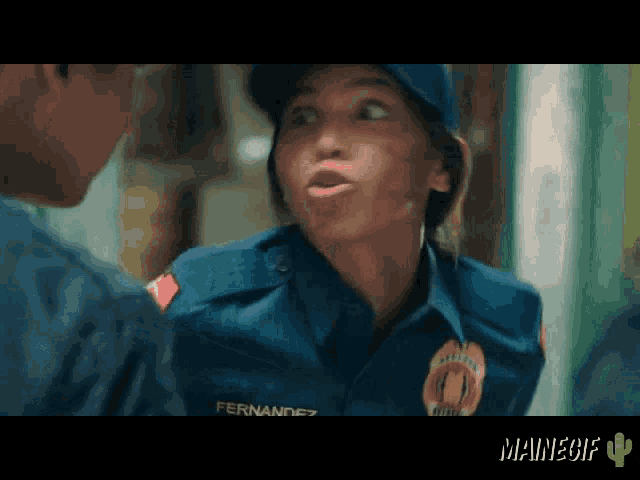 a woman in a police uniform has the name fernandez on her chest