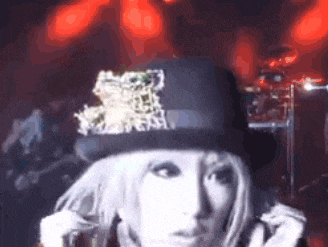 a woman wearing a top hat with a leopard print on it .