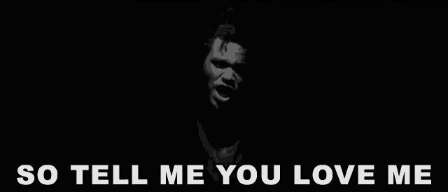 a black and white photo of a man with the words so tell me you love me