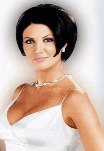 a woman in a white dress with a pearl necklace