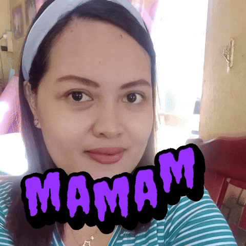 a woman is taking a selfie with the word mamam written on her face