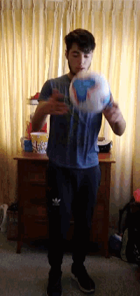a man in a blue adidas shirt stands in front of a dresser