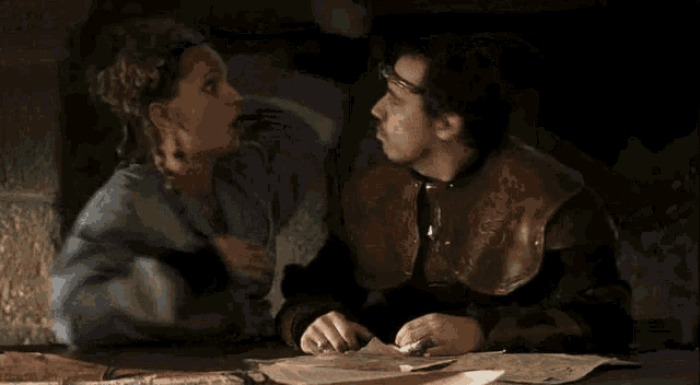 a man and a woman sitting at a table with the words j suis enceinte written on the bottom