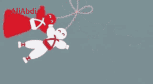 a drawing of two dolls hanging from a string with the name aliabdi in red