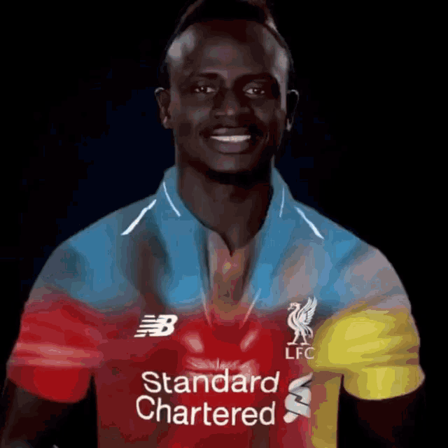 a man wearing a red blue and yellow shirt that says standard chartered