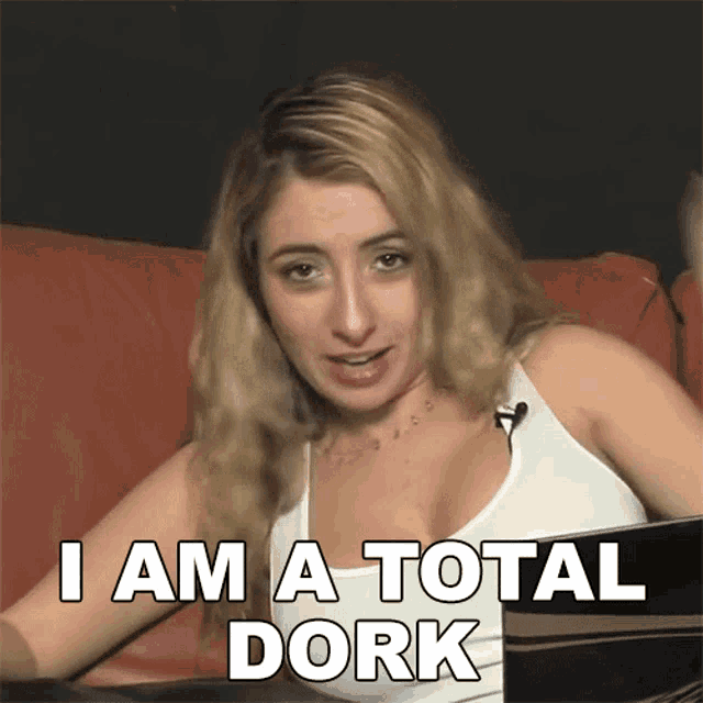 a woman sitting on a couch with the words i am a total dork behind her