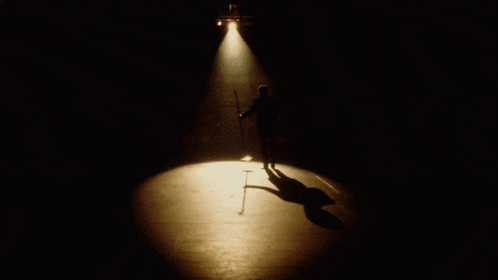 a spotlight is shining on a dark room