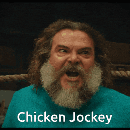 a man with a beard is wearing a blue shirt with the words chicken jockey on it