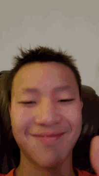 a close up of a person 's face with their eyes closed and a smile on their face