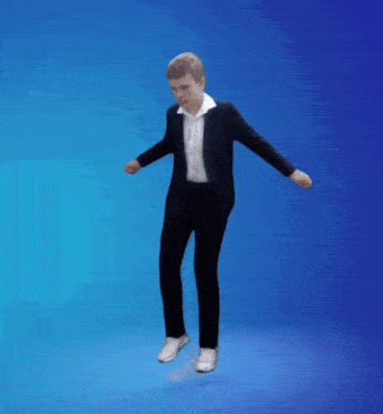 a young boy in a suit and white shirt is dancing on a blue background