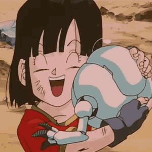 a girl in a red shirt is holding a robot in her arms and smiling