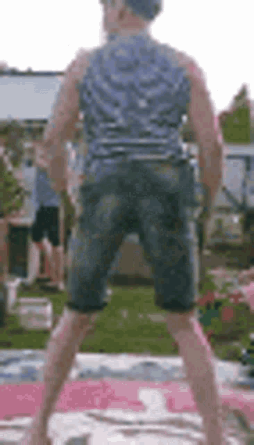 a man is standing on a blanket with a hula hoop around his neck .