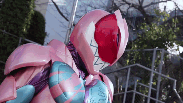 a close up of a pink and purple superhero costume