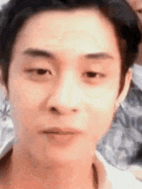 a close up of a man 's face with a blurred background
