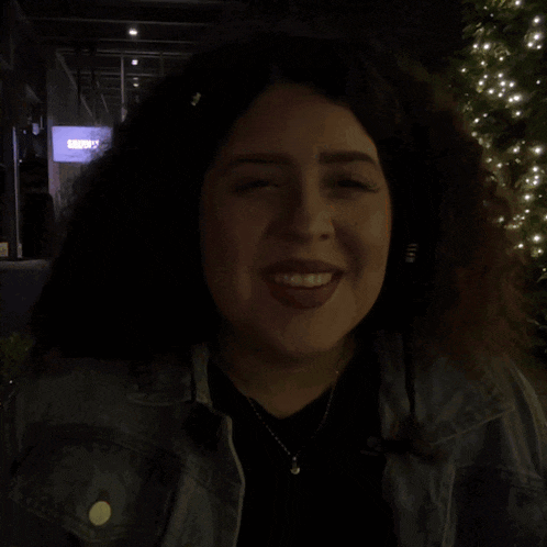 a woman is making a funny face in front of a sign that says subway