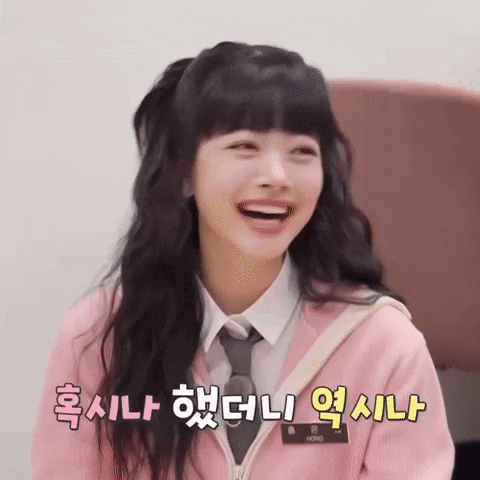 a girl wearing a pink jacket and tie is laughing