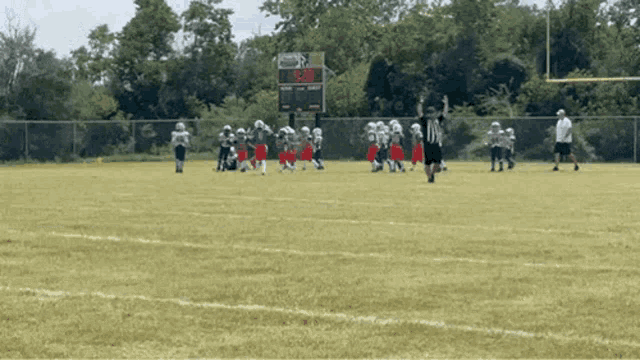 a football game is underway and the scoreboard shows 8:20
