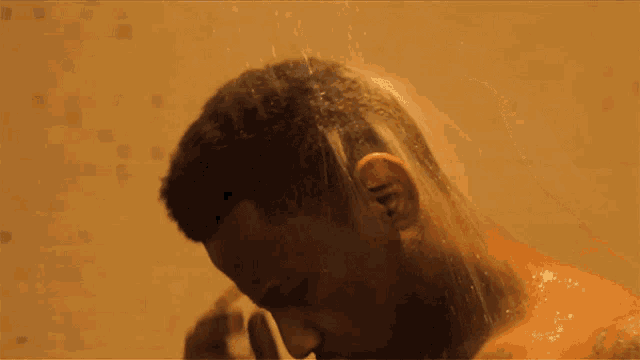 a man is taking a shower and washing his hair