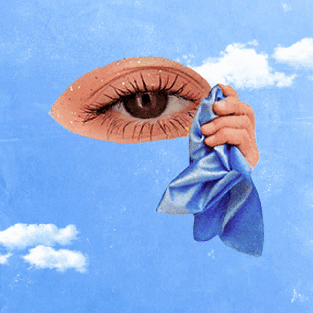 a hand is holding a piece of blue cloth in front of a woman 's eye