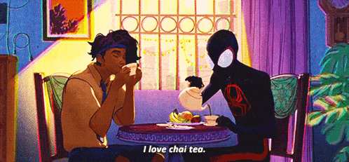 a man in a spiderman costume is pouring tea into another man 's cup