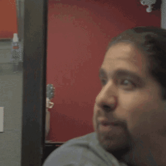 a man with a beard is making a funny face