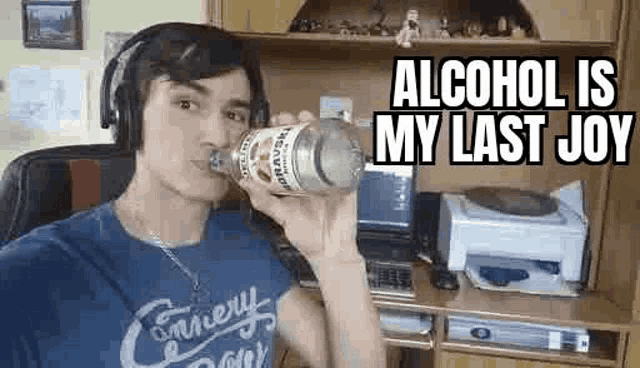 a man wearing headphones is drinking from a bottle of alcohol in a living room .