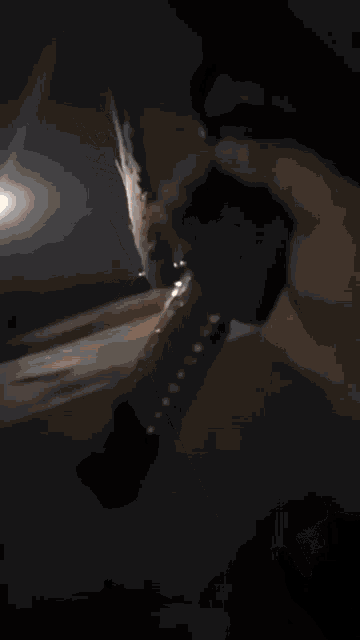 a silhouette of a person holding a gun against a black background