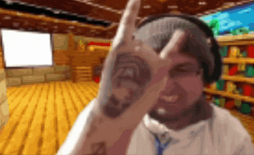 a man with a tattoo on his arm is making a peace sign