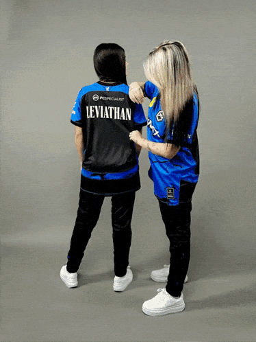 two women standing next to each other one wearing a leviathan shirt