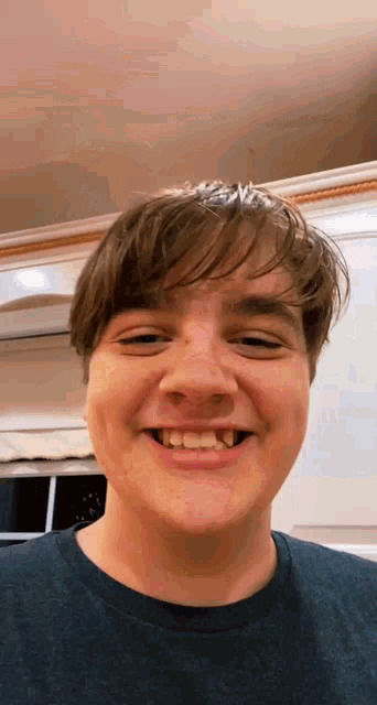 a man with a missing tooth smiles for the camera