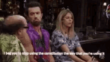 a group of people are sitting at a table and one of them is talking to another person .
