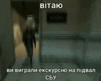 a man is walking down a hallway in front of a sign that says security .