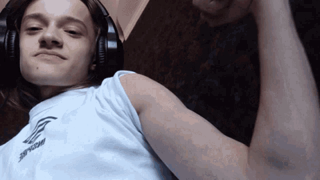 a young man wearing headphones and a white shirt that says inspire
