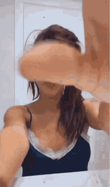 a woman is taking a picture of herself in a bathroom mirror .