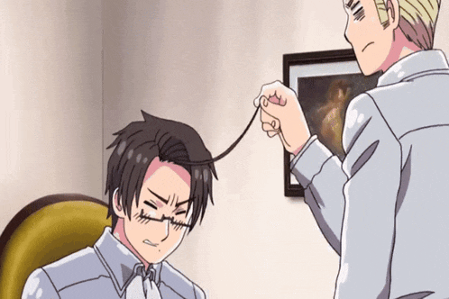 a man is playing with another man 's hair