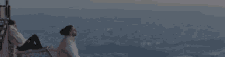 a couple sits on a balcony overlooking a city and the word kuta is on the bottom right