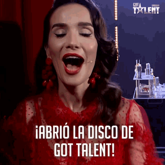 a woman in a red dress with her mouth open and the words " abrio la disco de got talent "