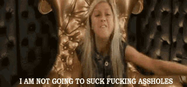 a girl is sitting in a chair with the words i am not going to suck fucking assholes