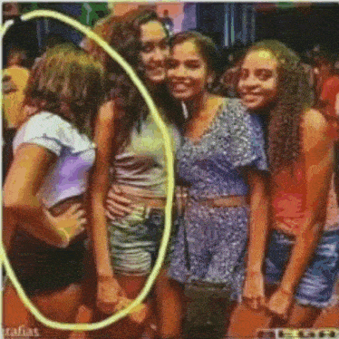 a group of young women are posing for a picture with a yellow circle around one of them .
