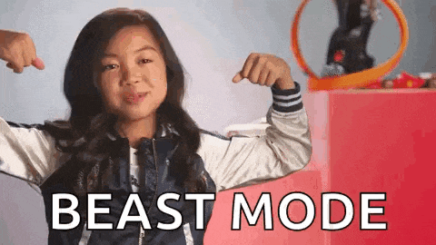 a young girl is flexing her muscles in front of a red box that says beast mode .