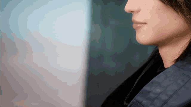 a close up of a woman 's face with a blurred background