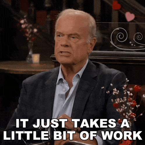a man in a suit says it just takes a little bit of work while sitting at a table