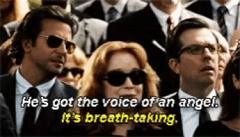 a group of people sitting in a crowd with a woman wearing sunglasses saying he 's got the voice of an angel