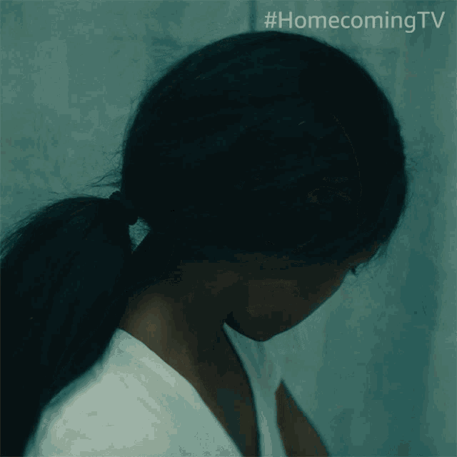 a close up of a woman 's face with #homecomingtv written on the bottom